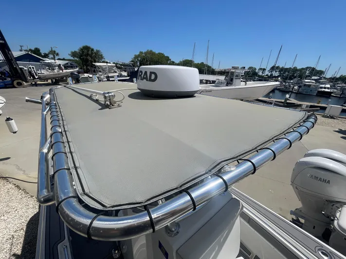  Yacht Photos Pics 2022 Contender 25 Tournament boat with radar, docked at a marina under clear blue skies.