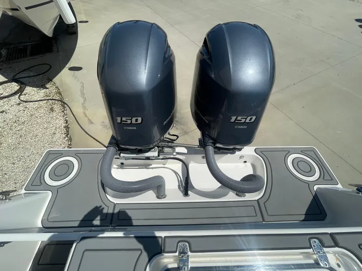  Yacht Photos Pics Twin Yamaha 150 engines on a 2022 Contender 25 Tournament boat, docked on concrete.