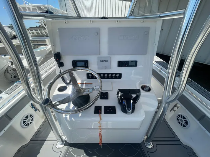  Yacht Photos Pics 2022 Contender 25 Tournament boat console with steering wheel and controls.