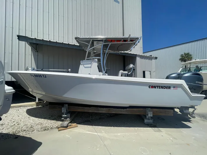  Yacht Photos Pics 2022 Contender 25 Tournament boat on display outside a warehouse.