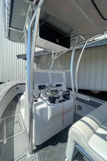  Yacht Photos Pics 2022 Contender 25 Tournament boat interior with steering console and seating.