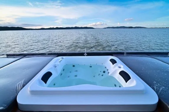 Evita Yacht Photos Pics Luxurious hot tub on 2025 Custom NAUTICKS 62 yacht with ocean view.