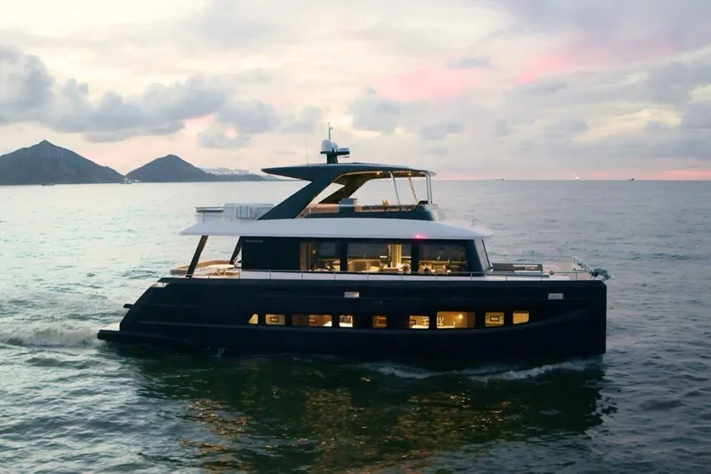 Evita Yacht Photos Pics Luxurious 2025 Custom NAUTICKS 62 yacht cruising at sunset with scenic mountain backdrop.