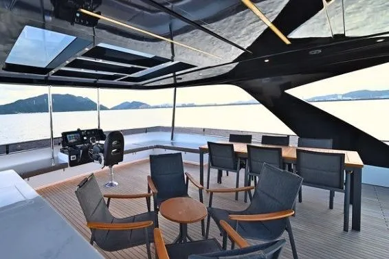 Evita Yacht Photos Pics Luxurious 2025 NAUTICKS 62 yacht deck with modern seating and ocean view.