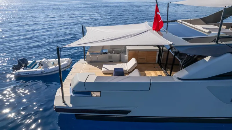 Mama Punch Yacht Photos Pics Luxurious 2021 Bluegame BGX70 yacht with sun deck and tender on calm sea.