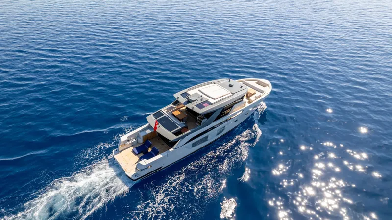 Mama Punch Yacht Photos Pics 2021 Bluegame BGX70 yacht cruising on open blue sea under clear skies.