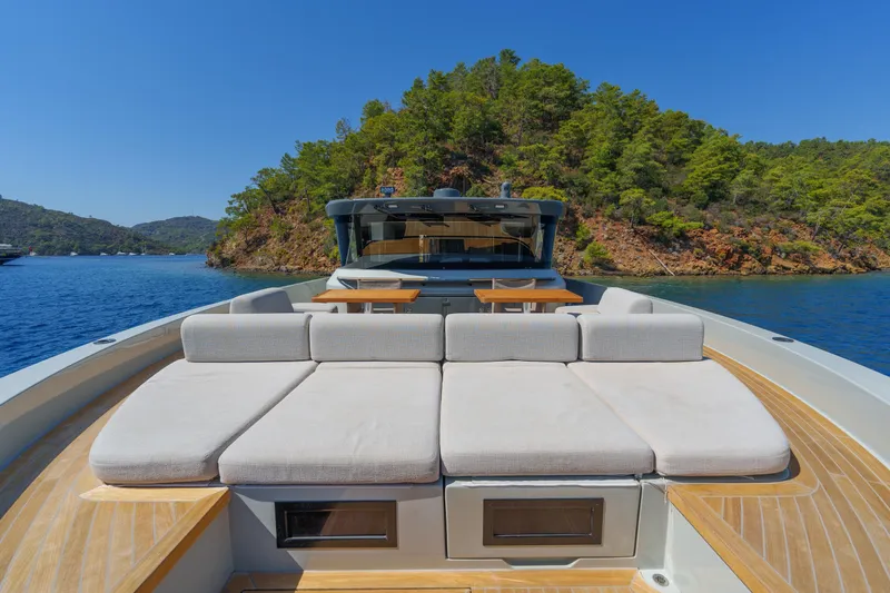 Mama Punch Yacht Photos Pics Luxury Bluegame BGX70 yacht with sunbathing area, cruising near lush island, 2021 model.