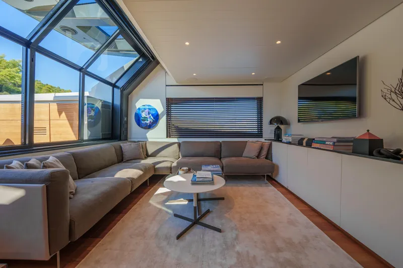 Mama Punch Yacht Photos Pics Luxurious interior of 2021 Bluegame BGX70 yacht with modern furnishings and large windows.