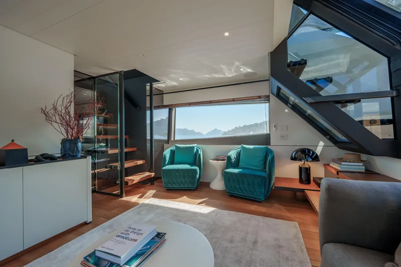 Mama Punch Yacht Photos Pics Luxurious interior of 2021 Bluegame BGX70 yacht with modern seating and scenic window view.