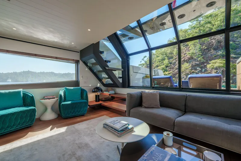 Mama Punch Yacht Photos Pics Luxurious interior of 2021 Bluegame BGX70 yacht with modern seating and panoramic windows.