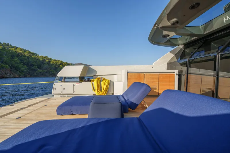Mama Punch Yacht Photos Pics Luxurious Bluegame BGX70 yacht deck with blue loungers, 2021 model, scenic ocean view.