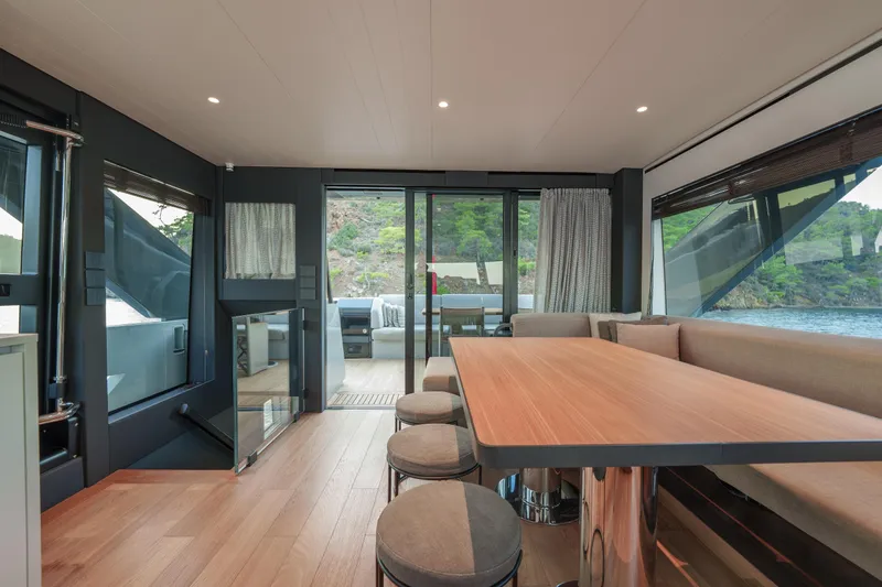 Mama Punch Yacht Photos Pics Luxurious interior of 2021 Bluegame BGX70 yacht with modern dining area and scenic views.