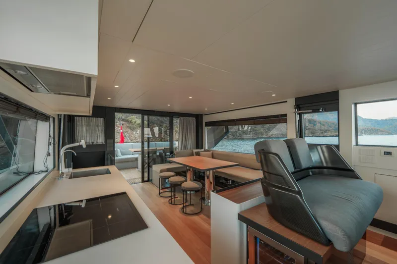 Mama Punch Yacht Photos Pics Interior of 2021 Bluegame BGX70 yacht with modern kitchen and seating area.