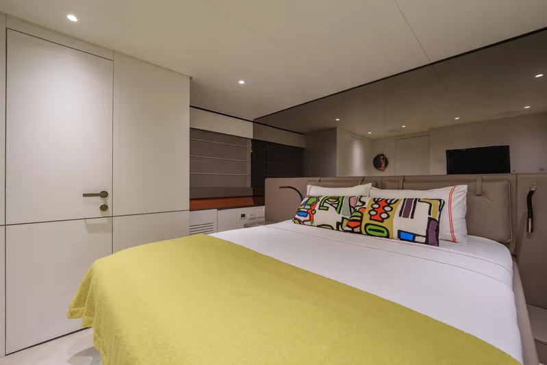 Mama Punch Yacht Photos Pics Luxurious bedroom interior of 2021 Bluegame BGX70 yacht with modern decor and vibrant bedding.
