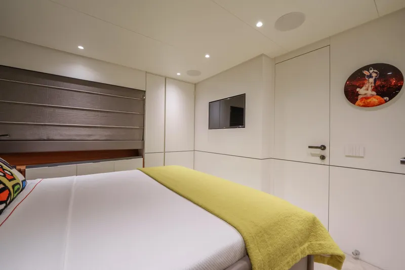 Mama Punch Yacht Photos Pics Luxurious bedroom interior on 2021 Bluegame BGX70 yacht, featuring modern decor and cozy bedding.