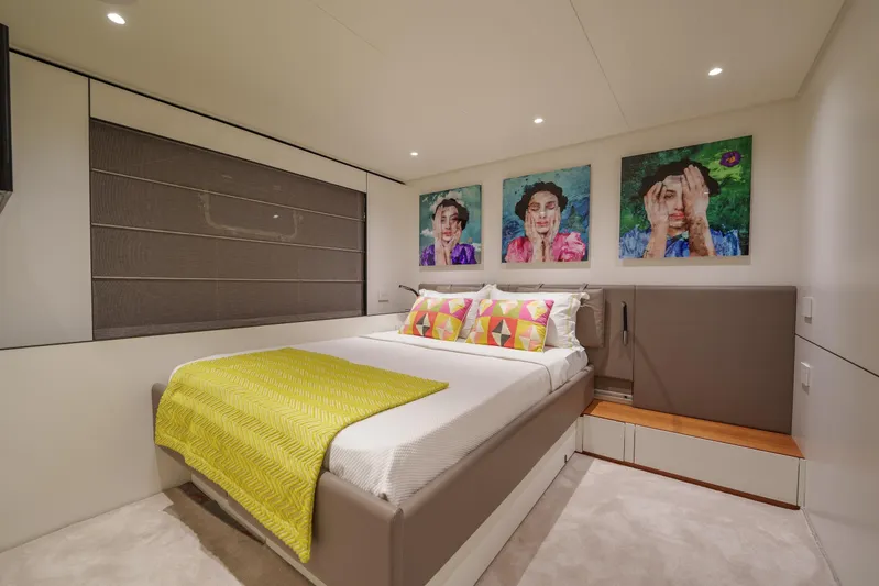 Mama Punch Yacht Photos Pics Luxurious Bluegame BGX70 2021 yacht bedroom with modern decor and vibrant artwork.