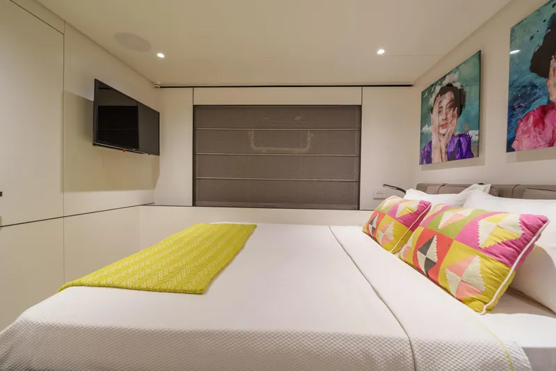 Mama Punch Yacht Photos Pics Luxurious bedroom interior of 2021 Bluegame BGX70 yacht with modern decor and vibrant accents.