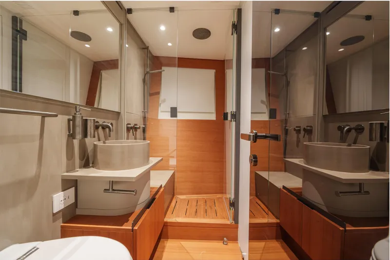Mama Punch Yacht Photos Pics Luxurious bathroom interior of 2021 Bluegame BGX70 yacht, featuring modern fixtures and wooden accents.