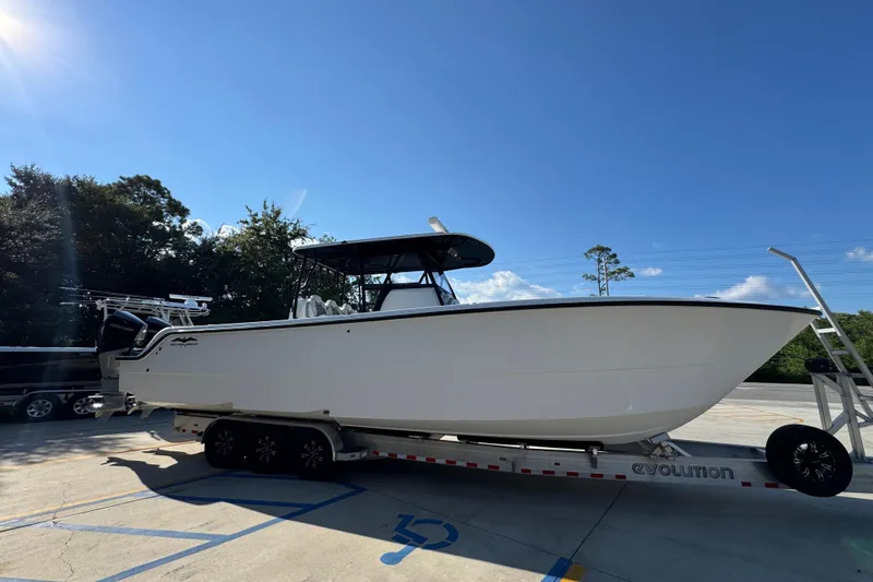  Yacht Photos Pics 2023 Invincible 35 Catamaran on trailer under clear blue sky.