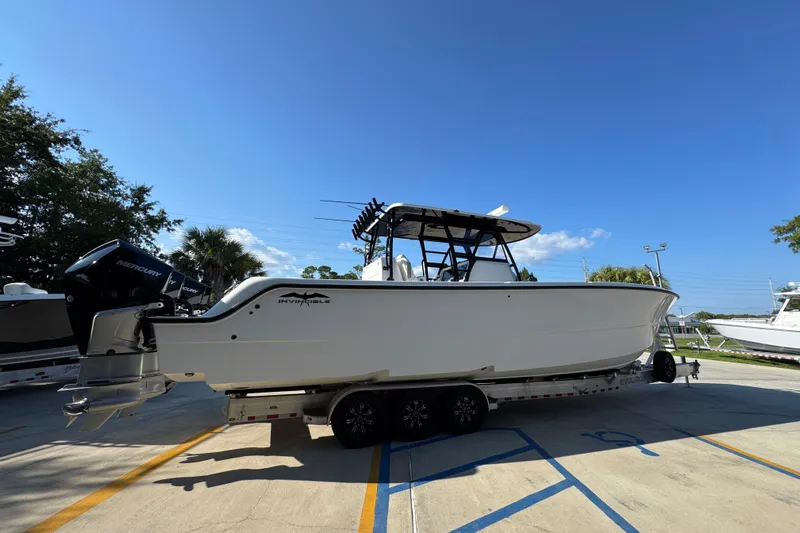 Yacht Photos Pics 2023 Invincible 35 Catamaran on trailer, featuring dual Mercury engines, parked outdoors.
