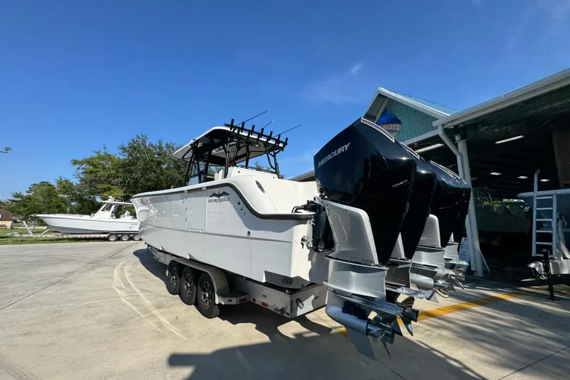  Yacht Photos Pics 2023 Invincible 35 Catamaran with Mercury engines, parked outdoors under clear blue sky.
