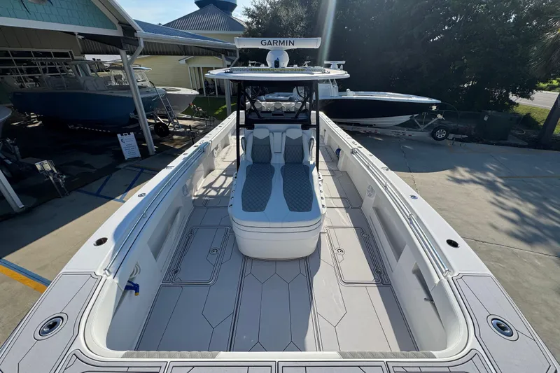  Yacht Photos Pics 2023 Invincible 35 Catamaran with spacious deck and modern seating, docked outdoors.