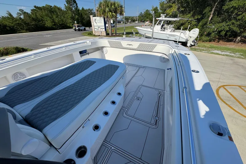  Yacht Photos Pics 2023 Invincible 35 Catamaran with spacious deck and comfortable seating, parked outdoors.