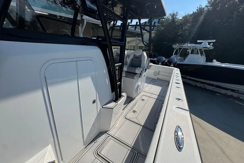  Yacht Photos Pics 2023 Invincible 35 Catamaran boat interior with seating and storage compartments.