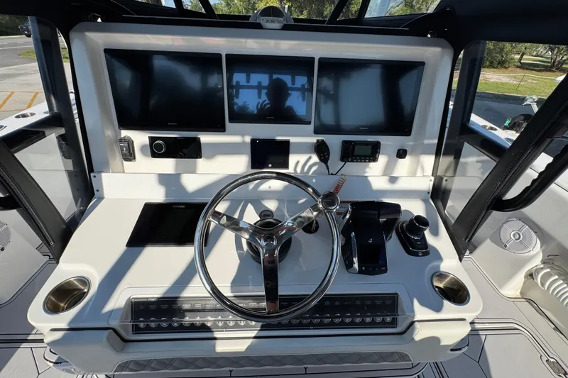  Yacht Photos Pics 2023 Invincible 35 Catamaran helm with modern controls and multiple display screens.