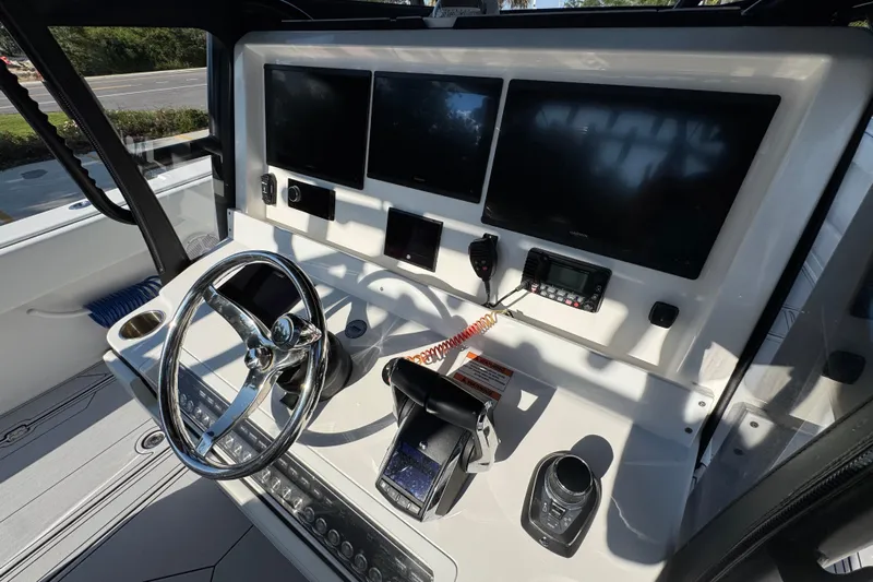  Yacht Photos Pics 2023 Invincible 35 Catamaran helm with modern controls and multiple display screens.