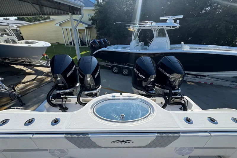  Yacht Photos Pics 2023 Invincible 35 Catamaran with Mercury engines, docked alongside other boats.