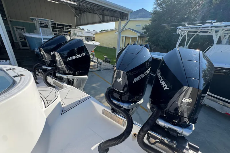  Yacht Photos Pics Four Mercury outboard engines on a 2023 Invincible 35 Catamaran, docked in a marina.