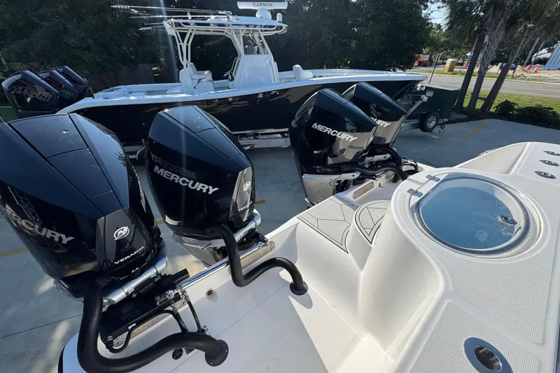  Yacht Photos Pics 2023 Invincible 35 Catamaran with four Mercury engines, docked outdoors.