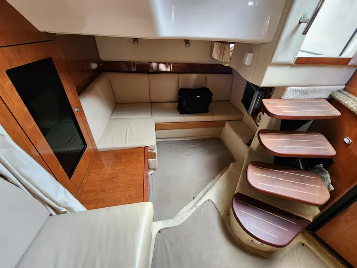  Yacht Photos Pics Interior of 2006 Sea Ray 38 Sundancer yacht with seating and wooden steps.