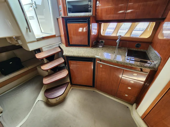  Yacht Photos Pics Interior of 2006 Sea Ray 38 Sundancer yacht with wooden cabinetry and compact kitchen area.