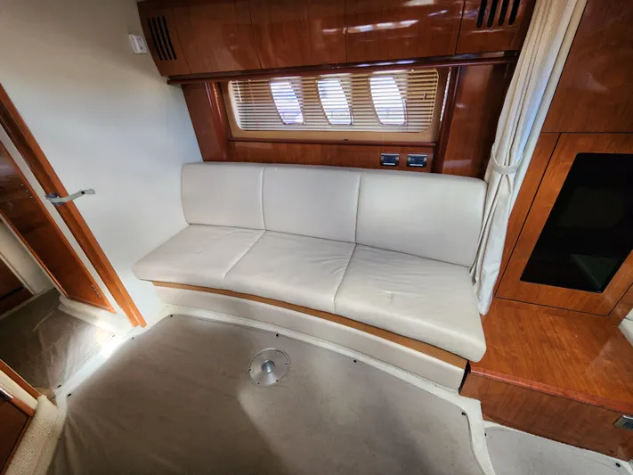  Yacht Photos Pics Interior of 2006 Sea Ray 38 Sundancer with cream leather seating and wooden accents.