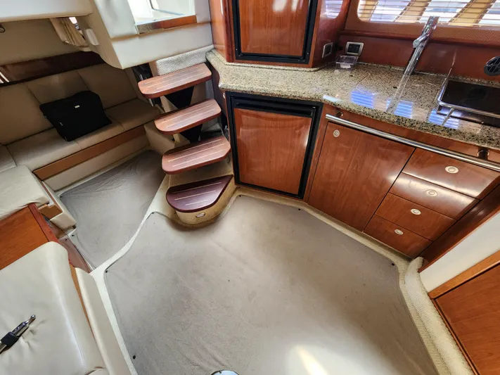  Yacht Photos Pics Interior of 2006 Sea Ray 38 Sundancer with wooden cabinetry and carpeted flooring.