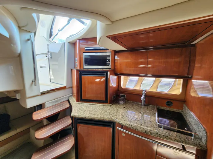  Yacht Photos Pics Interior of 2006 Sea Ray 38 Sundancer yacht with wooden cabinetry and granite countertops.