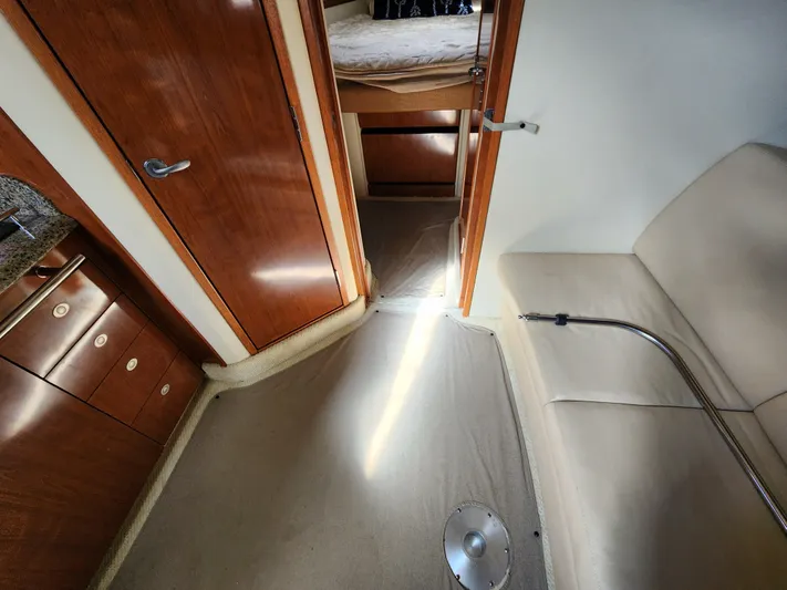  Yacht Photos Pics Interior of 2006 Sea Ray 38 Sundancer with wood cabinetry and beige seating.
