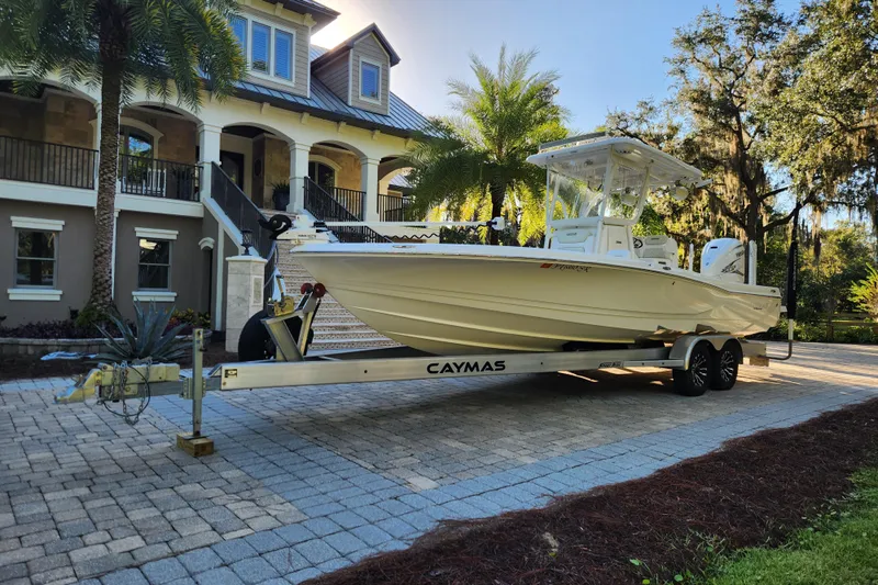  Yacht Photos Pics 2020 Caymas 28 HB boat on trailer in front of a luxurious house.
