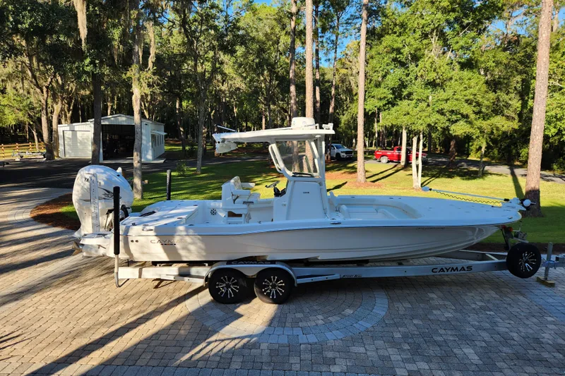  Yacht Photos Pics 2020 Caymas 28 HB boat on trailer in a wooded driveway setting.