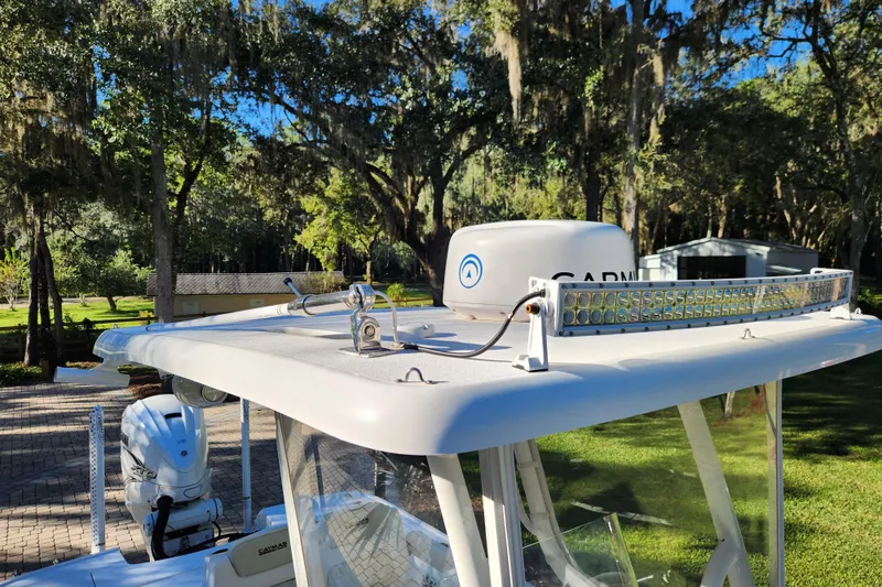  Yacht Photos Pics 2020 Caymas 28 HB boat with radar and light bar, surrounded by lush greenery.