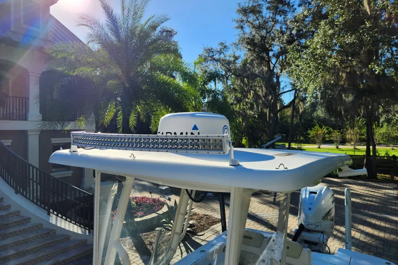  Yacht Photos Pics 2020 Caymas 28 HB boat with radar and light bar, surrounded by lush greenery.