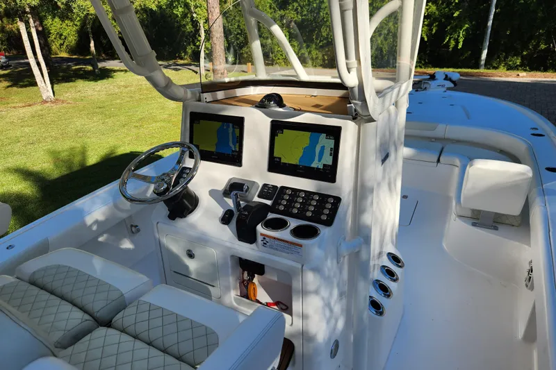  Yacht Photos Pics 2020 Caymas 28 HB boat cockpit with dual navigation screens and steering wheel.