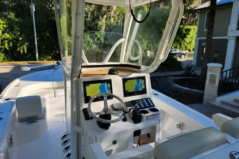  Yacht Photos Pics 2020 Caymas 28 HB boat cockpit with dual navigation screens and steering wheel.
