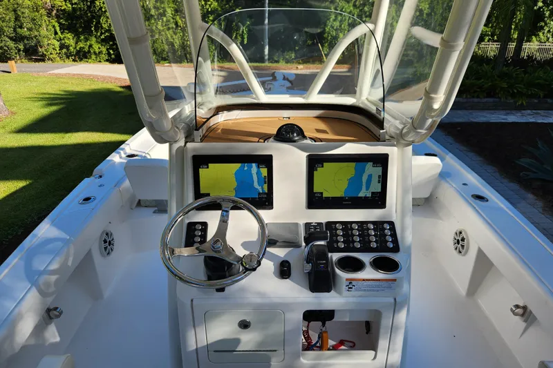  Yacht Photos Pics 2020 Caymas 28 HB boat cockpit with dual navigation screens and steering wheel.