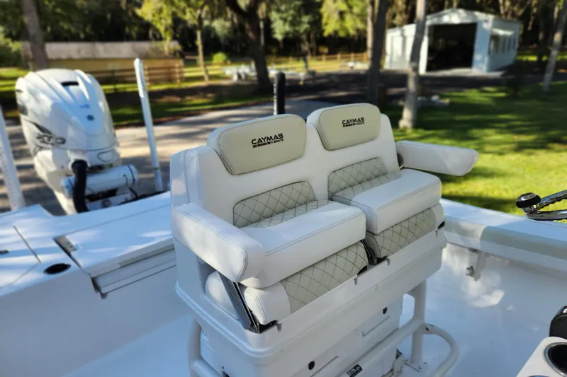  Yacht Photos Pics 2020 Caymas 28 HB boat interior with cushioned seating and outboard motor.