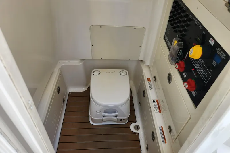  Yacht Photos Pics 2020 Caymas 28 HB boat interior with portable toilet and control panel.