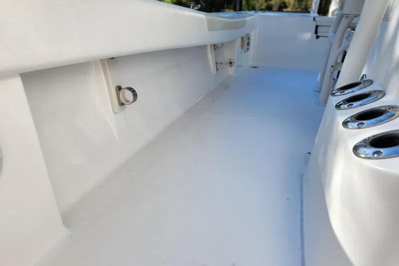  Yacht Photos Pics 2020 Caymas 28 HB boat interior with rod holders and sleek white deck.