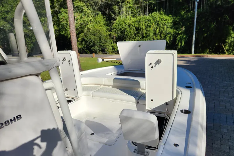  Yacht Photos Pics 2020 Caymas 28 HB boat interior with open storage compartments and seating.